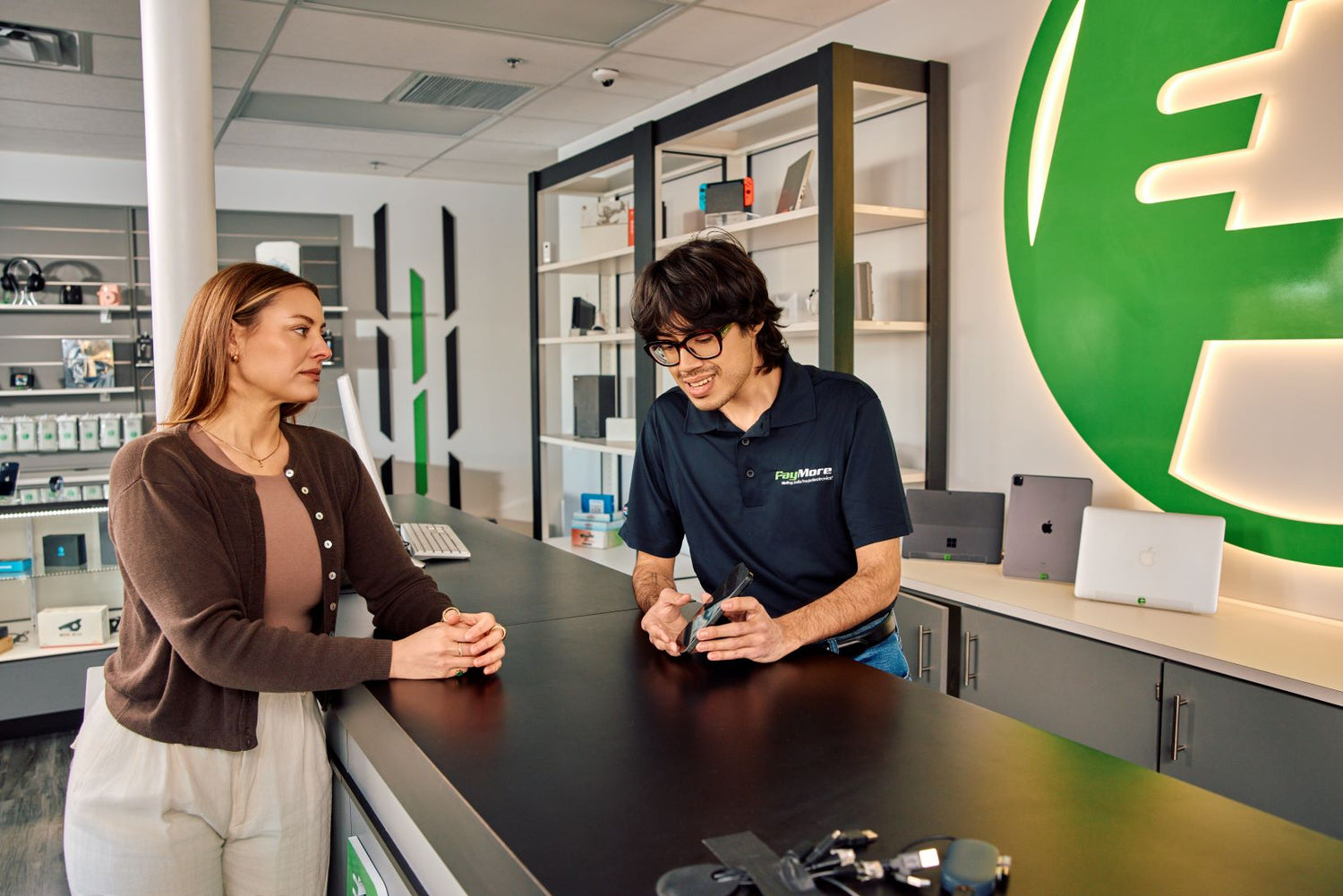 paymore employee inspecting a smartphone